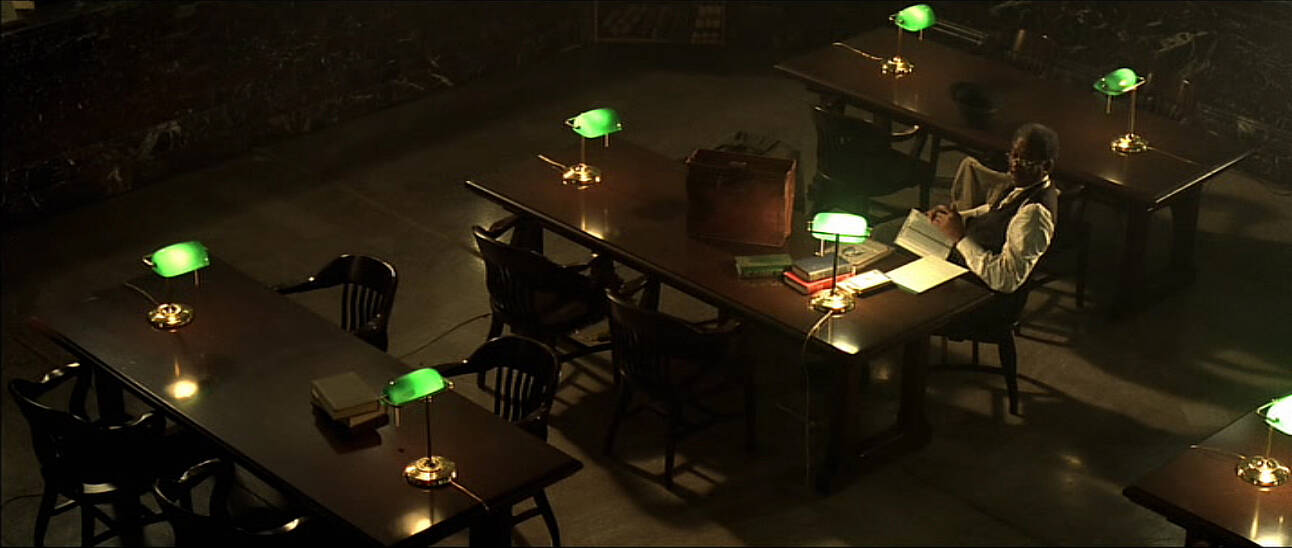 scene from the movie se7en with morgan freeman reading books.jpg