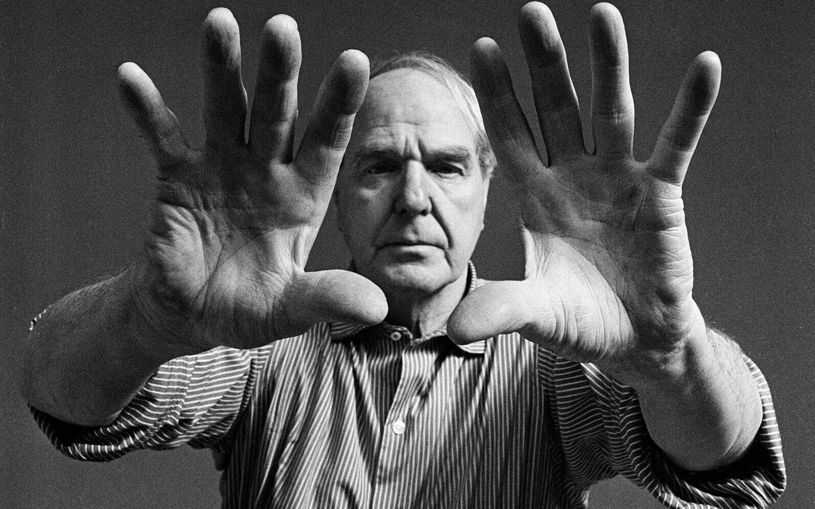 Portrait-of-the-artist-with-raised-hands-1968_Photo-John-Hedgecoe.jpg