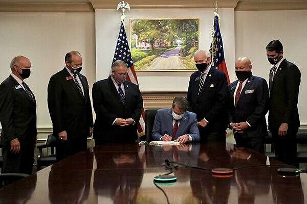 Brian Kemp signs Georgia voting law.jpeg